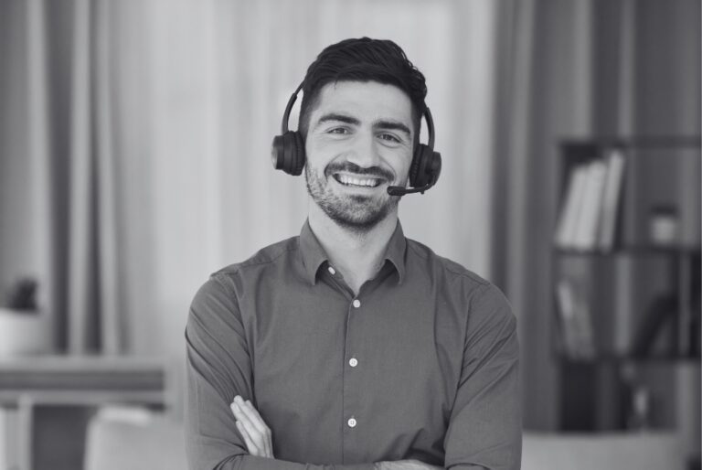 Man wearing headphones that work remotely in home office