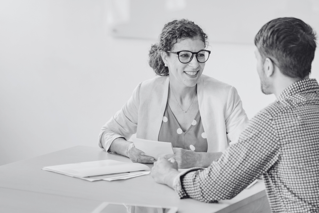 Woman interviewing man during recruitment process outsourcing